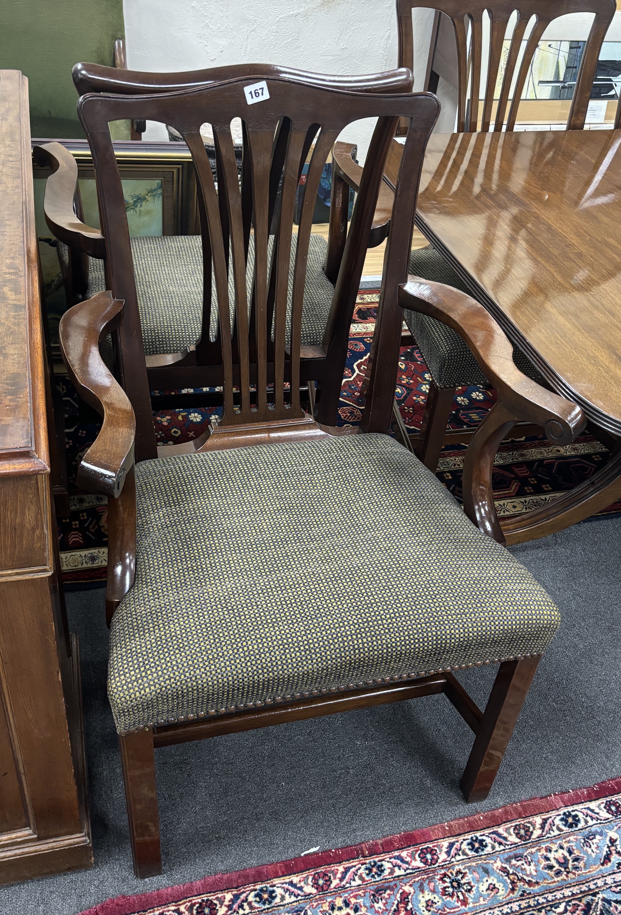 A set of twelve reproduction George III style mahogany dining chairs, ten single, two elbow chairs